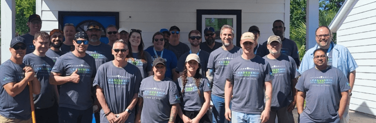 Legacy Supply Chain team stands in front of tiny home built in Glynn County
