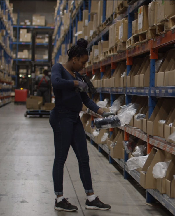 Woman scanning products in ecommerce fulfillment center