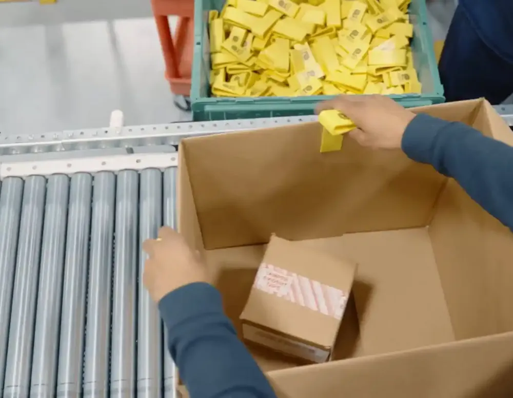Packing a box at a warehouse.