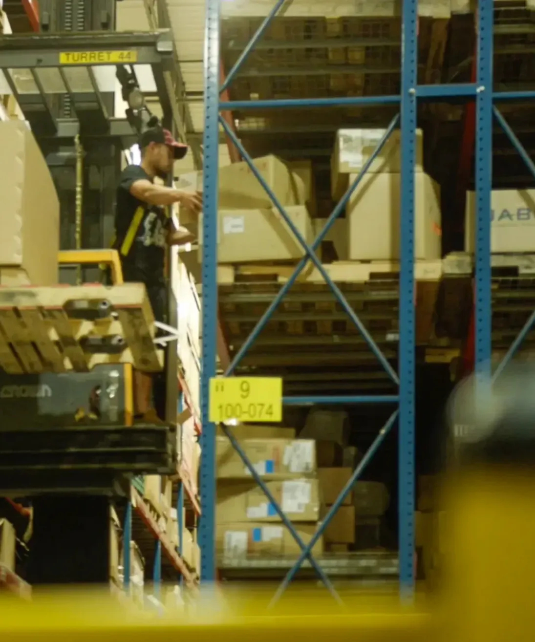 Legacy team member moving warehouse shelving